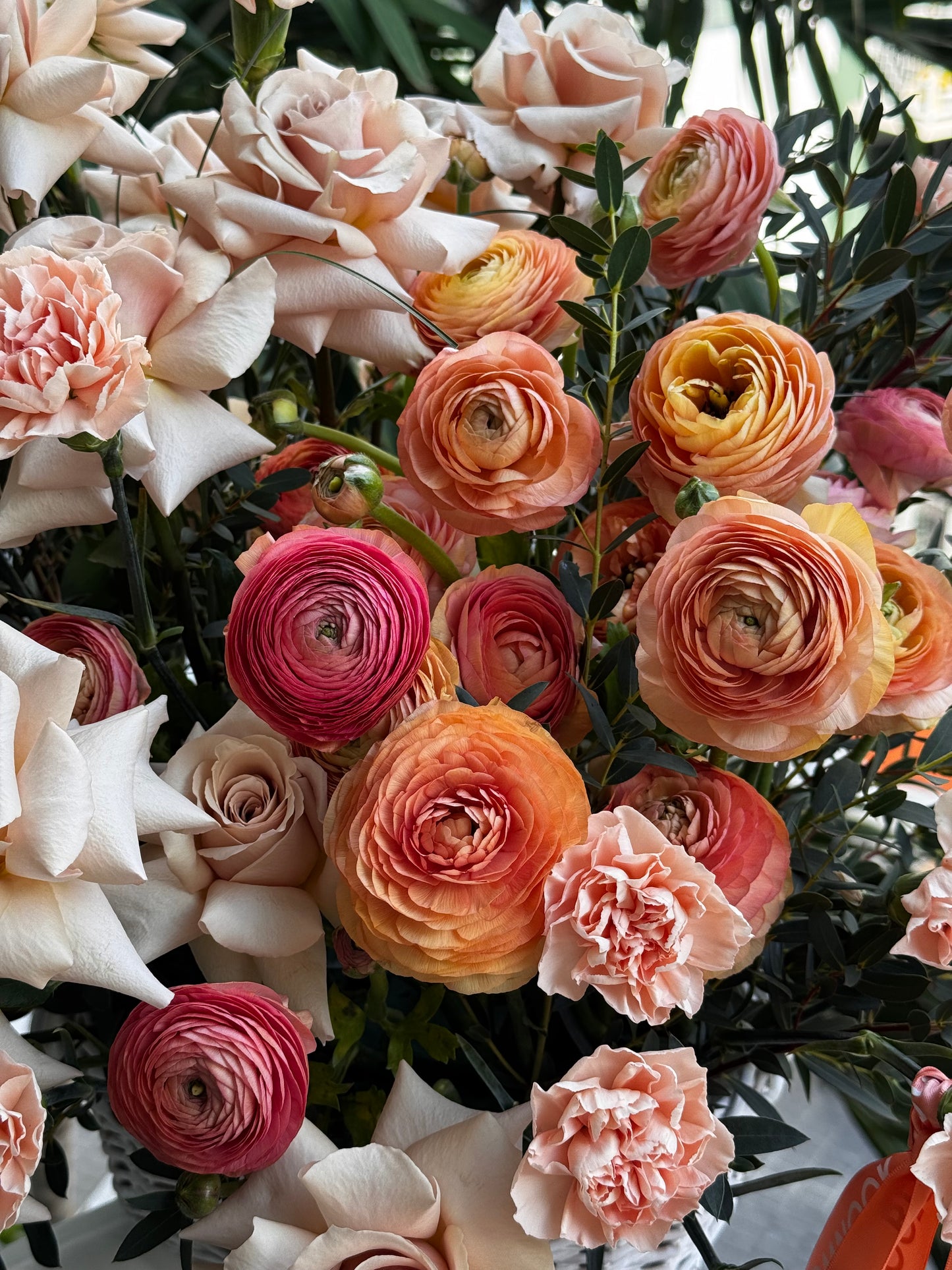 «Peach Whisper» ranunculus, French roses, eucalyptus, carnations